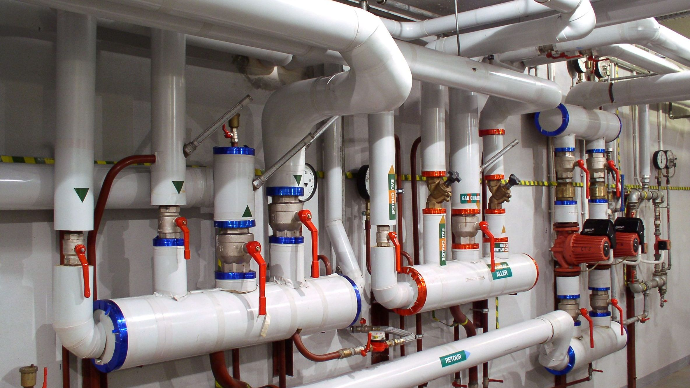 Hydronic heating and cooling piping system with pumps, valves, gauges, and controls